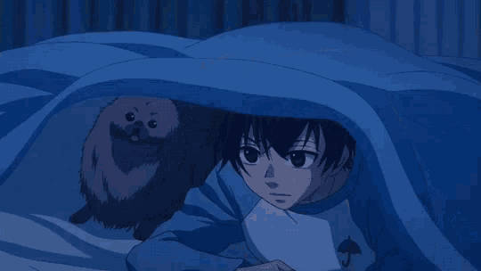 a boy in a blue shirt with an umbrella on it is hiding under a blue blanket