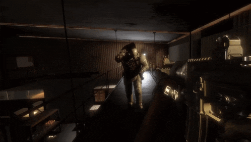 a person is holding a gun in a dark room