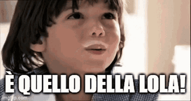 a young boy with white spots on his face and the words `` e quello della lola '' above him .