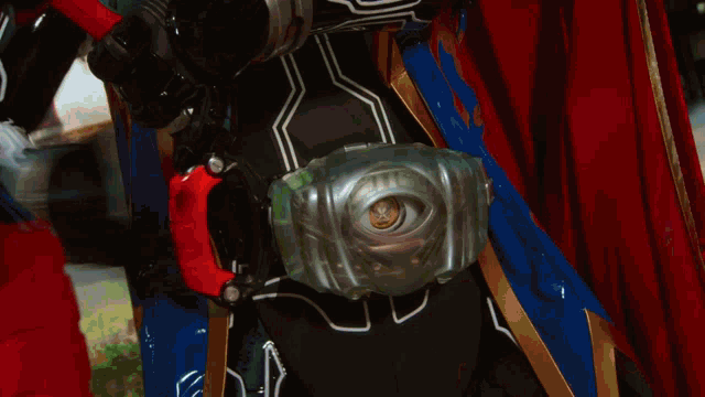 a close up of a person 's torso with a red cape on