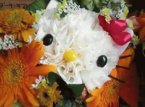 a close up of a hello kitty flower with a yellow center