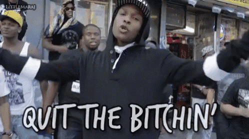 a man in a black hoodie says quit the bitchin ' in front of a crowd