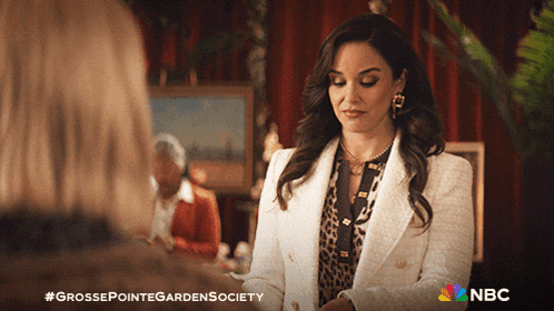 a woman in a white jacket is talking to another woman in a nbc ad