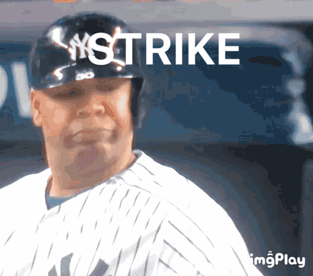 a baseball player wearing a helmet that says strike