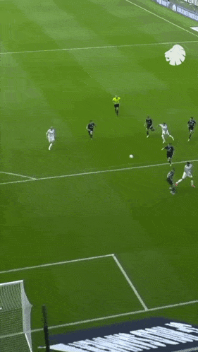 a group of soccer players are playing on a field with a banner that says ' allianz ' on it