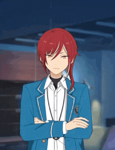 a boy with red hair and a blue jacket is standing with his arms crossed in a room .