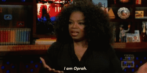 oprah winfrey is sitting in front of a bookshelf and saying i am oprah