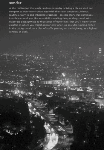 a black and white photo of a city at night with the word sonder on the bottom