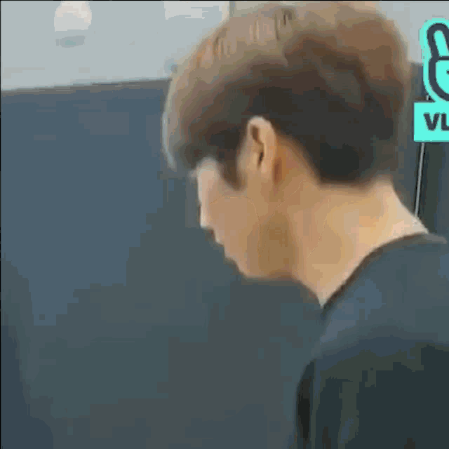 a close up of a person 's face with their mouth open and a sign that says vlive on it .