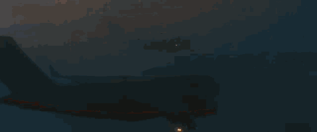 two planes are flying over a mountain range at sunset