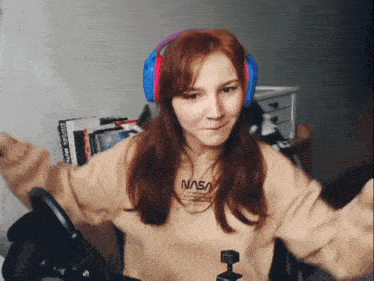 a woman wearing headphones and a nasa sweater