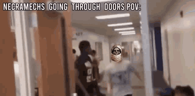 a group of people are walking through a hallway with a skull in the background .