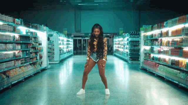 a woman in a leopard print top is dancing in a store