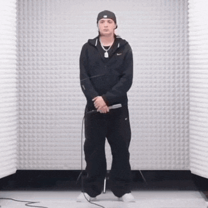 a man is standing in front of a microphone in a room holding a microphone .