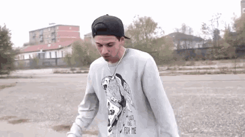 a young man wearing a baseball cap and a sweater that says `` lost one for me ''