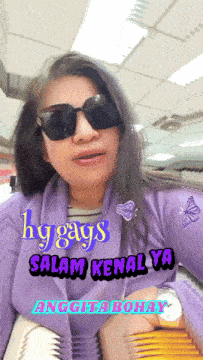 a woman wearing sunglasses and a purple shirt says hygges salam kenalya