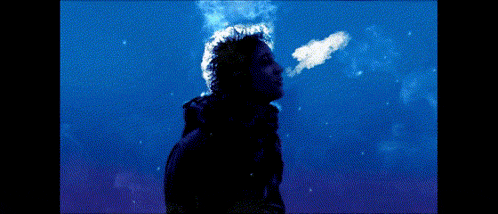a silhouette of a man smoking a cigarette with a blue background