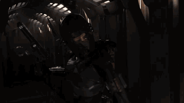 a blurred image of soldiers in a hallway with a red light