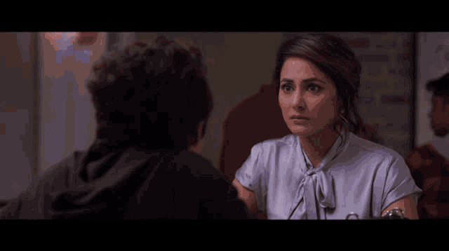 a woman is making a funny face while talking to another person