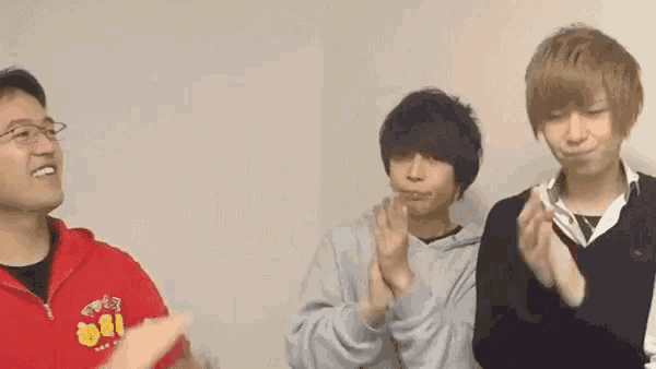 a group of young men are clapping their hands together .