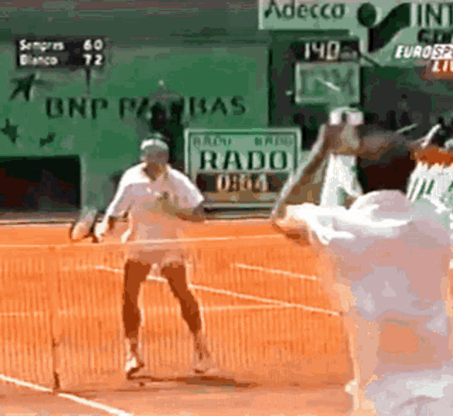 a tennis match is being played in front of a sign that says adecco