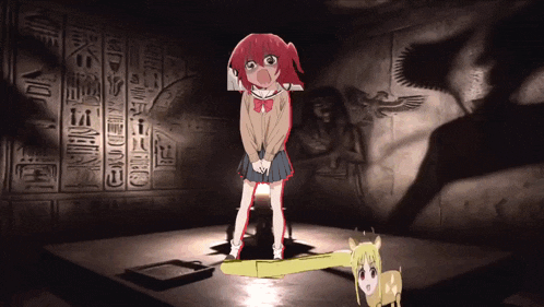 a girl with red hair is standing in front of a wall with hieroglyphs