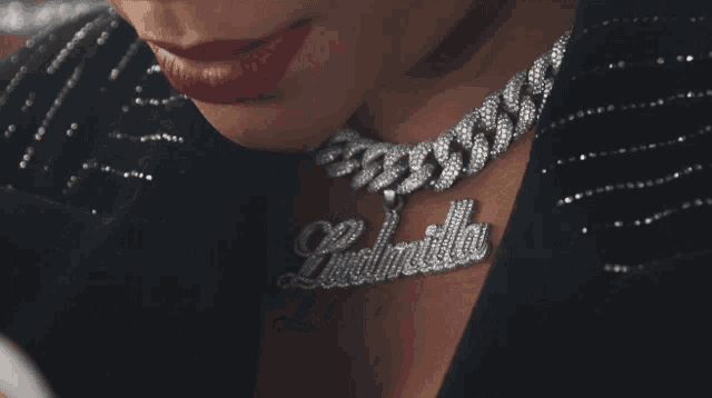 a close up of a woman wearing a necklace with the name cinderella