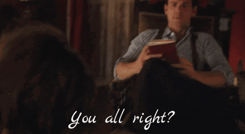 a man in a striped shirt is talking to another man with the words " you all right " written below him