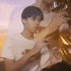a blurry picture of a man holding another man 's hand .
