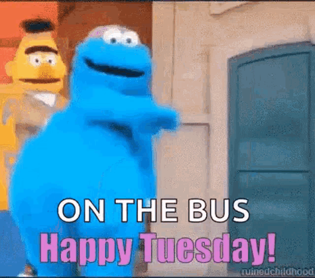 a cookie monster is standing in front of a door with the words `` on the bus happy tuesday '' written on it .