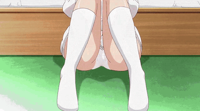 a girl in white knee high socks is sitting on the floor with her legs crossed