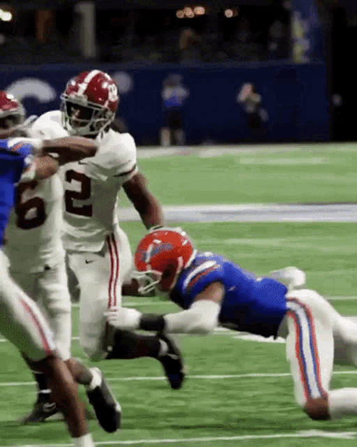 a football player with the number 2 on his jersey is being tackled