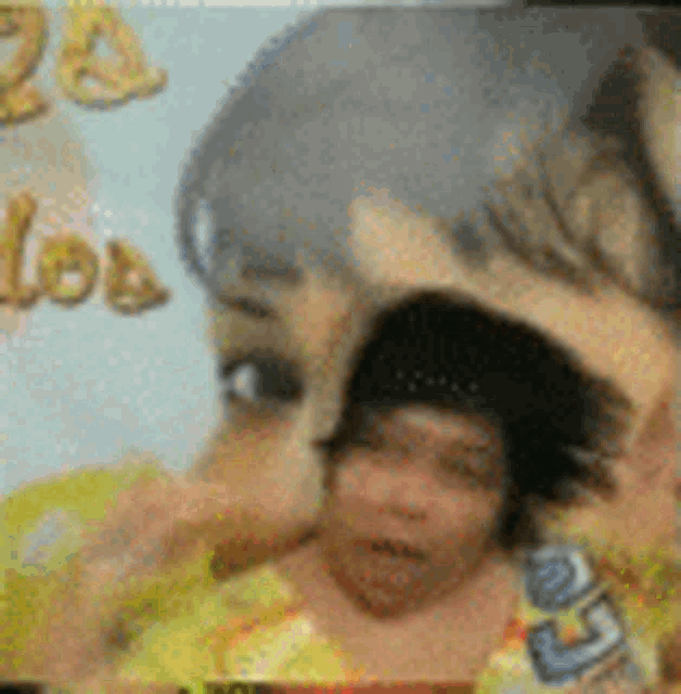 a close up of a woman 's face with a baby in front of her