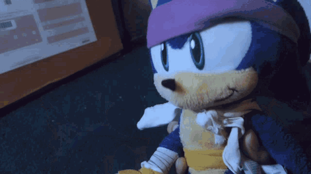 a sonic the hedgehog stuffed animal with a purple headband