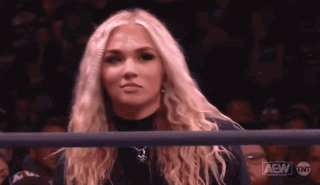 a woman in a wrestling ring with the word aew on the bottom right