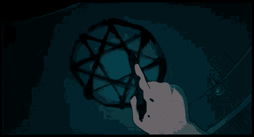 a hand is pointing at a pentagram on a wall