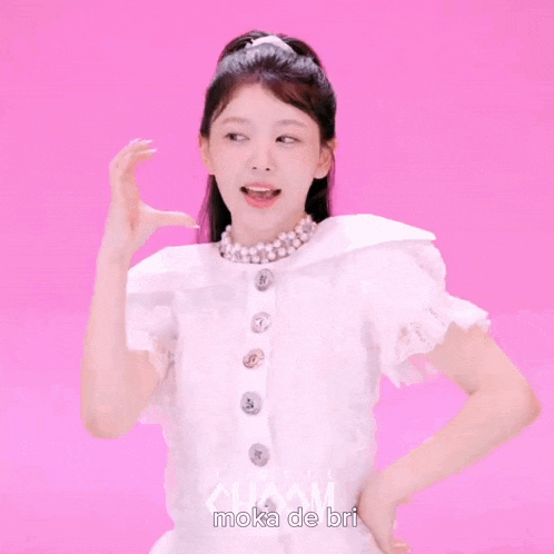 a girl wearing a white top and a pearl necklace with the name moka de bri on the bottom