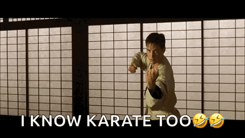 a man in a karate uniform is standing in front of a window and says i know karate too