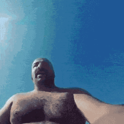 a man without a shirt is taking a picture of himself