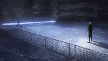 a person standing on a sidewalk in front of a fence that has a sign that says ' ae ' on it