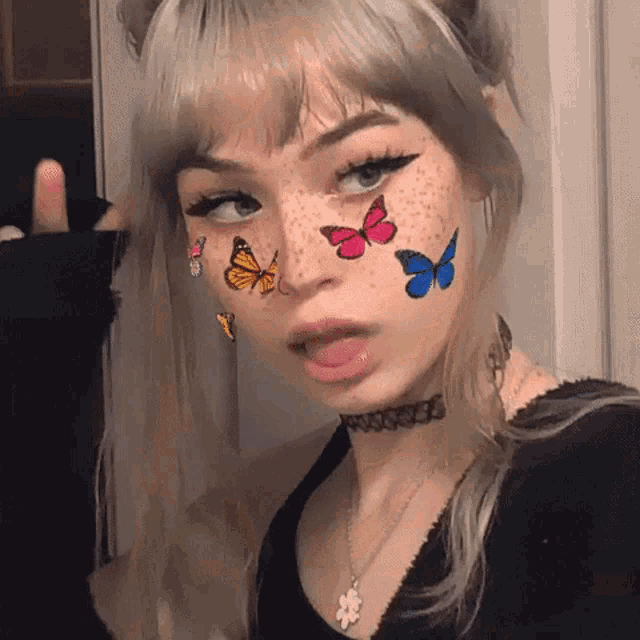 a woman with butterflies painted on her face