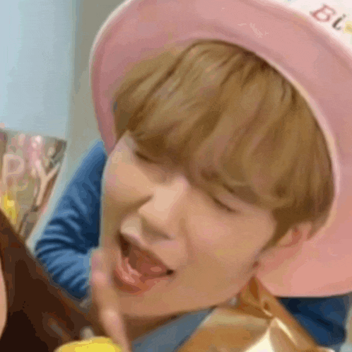 a close up of a person wearing a pink hat that says ' happy birthday ' on it