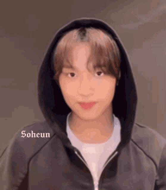 a young man wearing a black hoodie with the name soheun written on the bottom