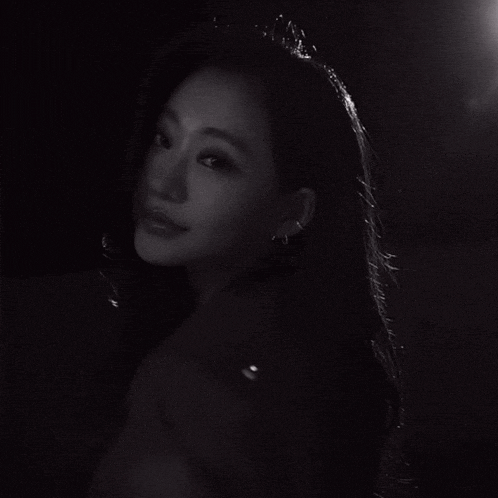a black and white photo of a woman 's face