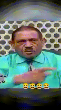 a man wearing a green shirt and tie is pointing at something