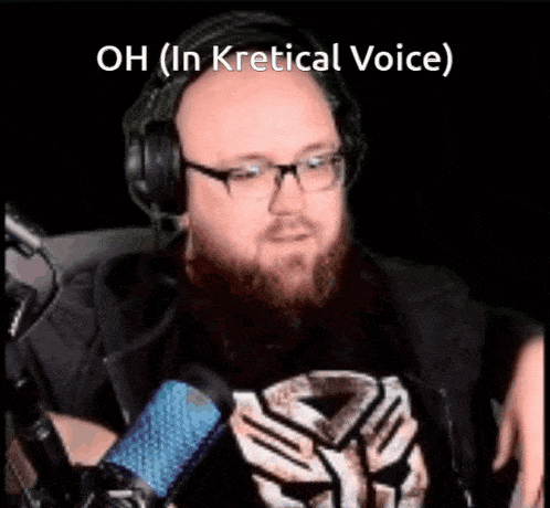 a man with a beard is wearing headphones and a transformer shirt .