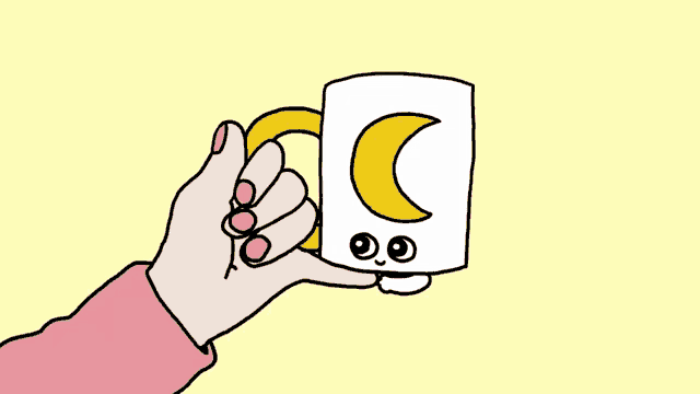 a hand is holding a mug with a yellow crescent moon on it