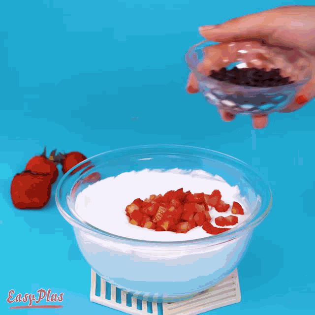 a bowl of yogurt with strawberries on top and easy plus in the corner