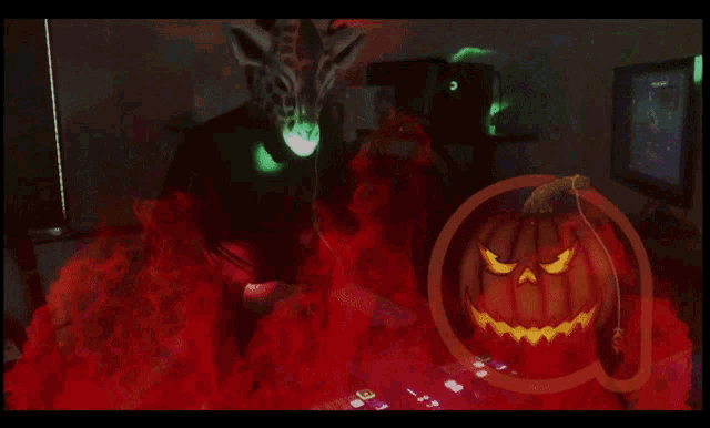 a pumpkin with an evil face is surrounded by fire