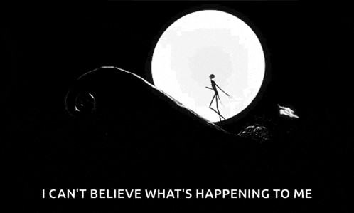 jack skellington is standing on a hill in front of a full moon in a black and white photo .